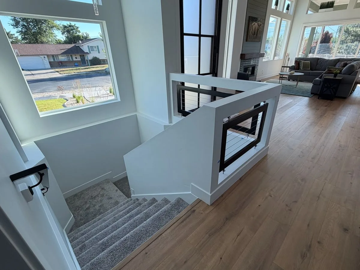 Carpeted staircase and wood-floored upper landing before a stairlift was installed